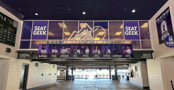 This photo shows the entry to Coors Field from Gate D. The day’s lineup is featured above the walkway.