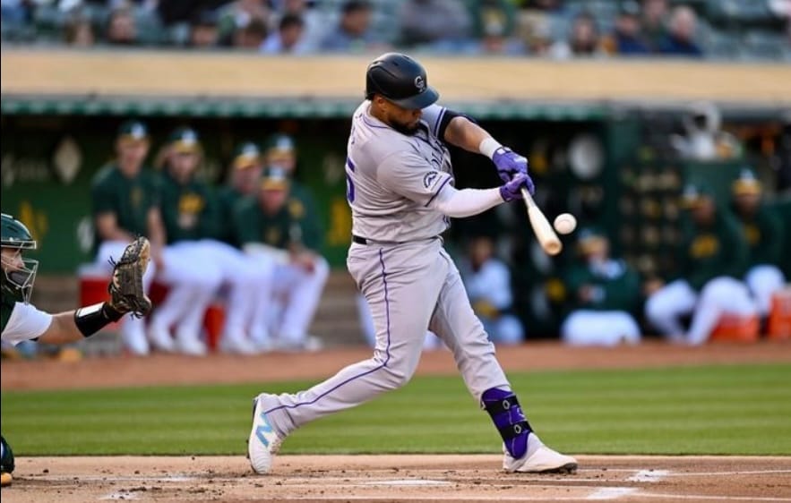 Díaz makes contact at the plate. He’s wearing road grays.