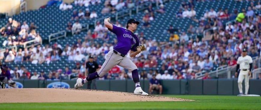 Quantrill in the windup. He’s wearing a purple jersey.