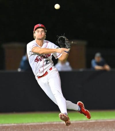 Wearing a white Indians uniform, Karros throws to first.