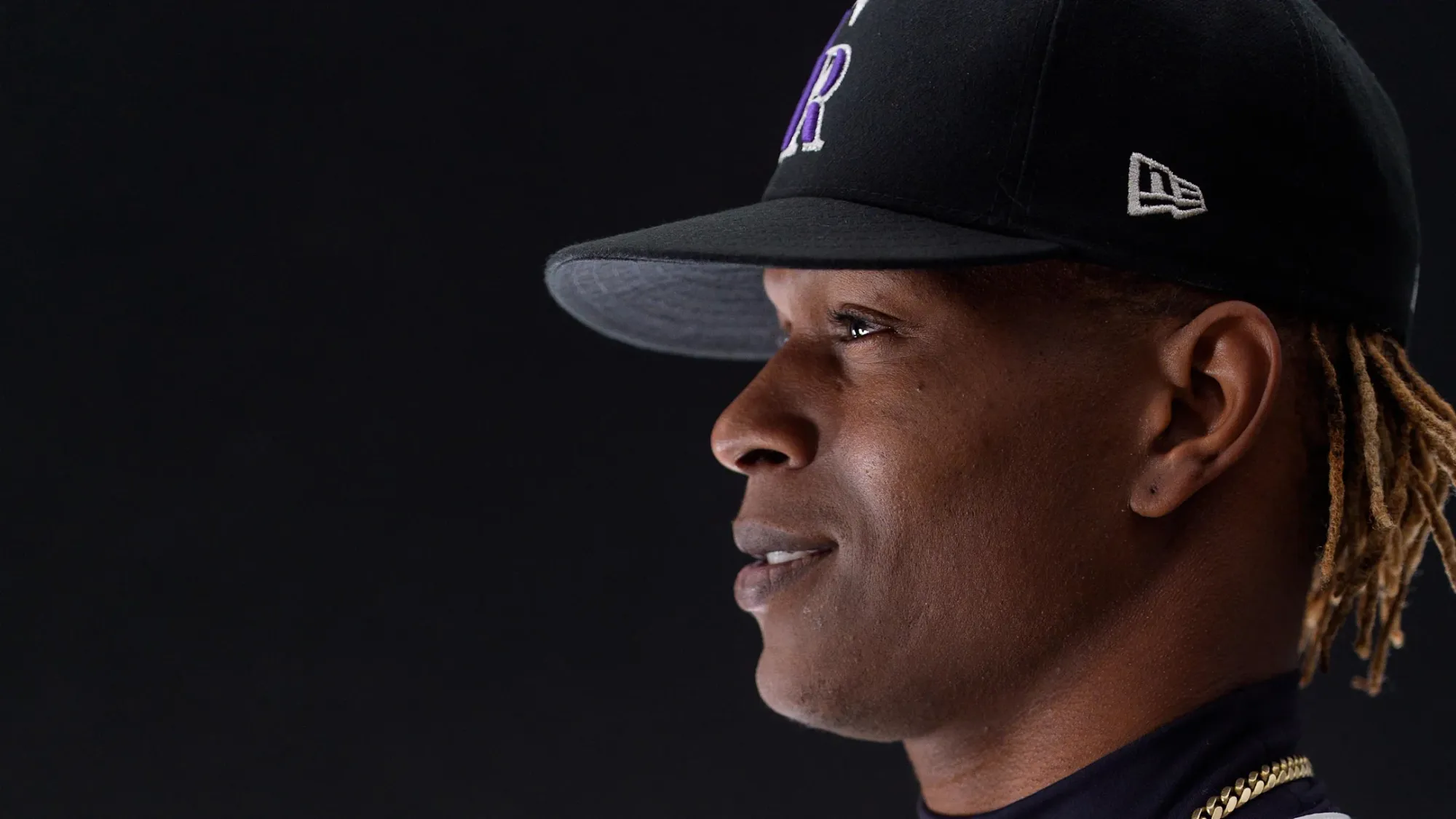 It’s from Photo Day — a side pic of Yan wearing a black Rockies cap and gold chain.