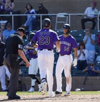 Tovar greets Bryant at home plate after he hit a home run.