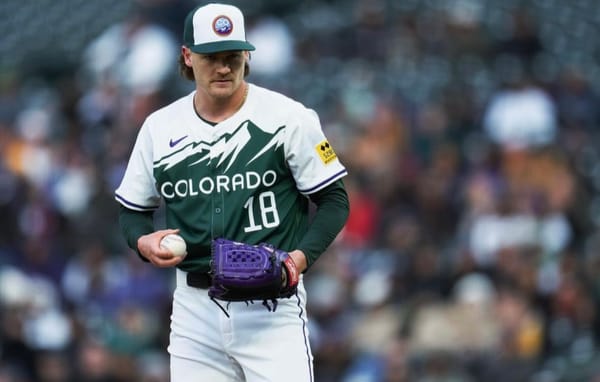 Feltner prepares to pitch. He’s wearing the Rockies green City Connect with a purple glove.