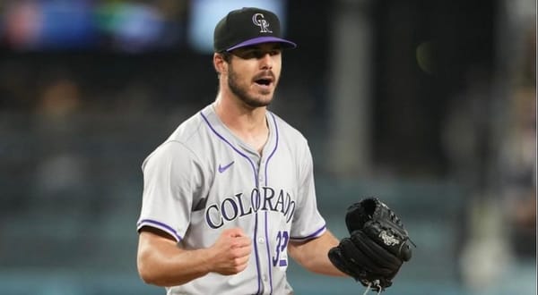 Hudson celebrates after something positive happens. He’s wearing road grays and has a black glove