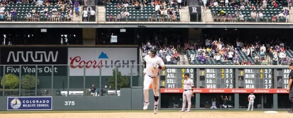 Doyle rounds first after hitting a home run. He’s wearing purple pinstripes.