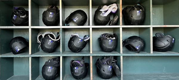 The Rockies’ batting helmets, stored in a green cubby.