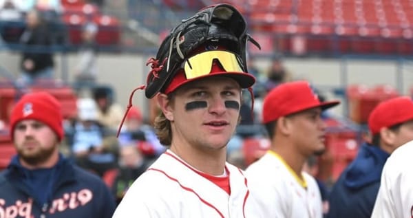 Carrigg looks at the camera, mirror shades and his glove on his head.