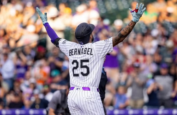 Warning Bernabel raises his arms in triumph. The pic shows the back of his jersey.